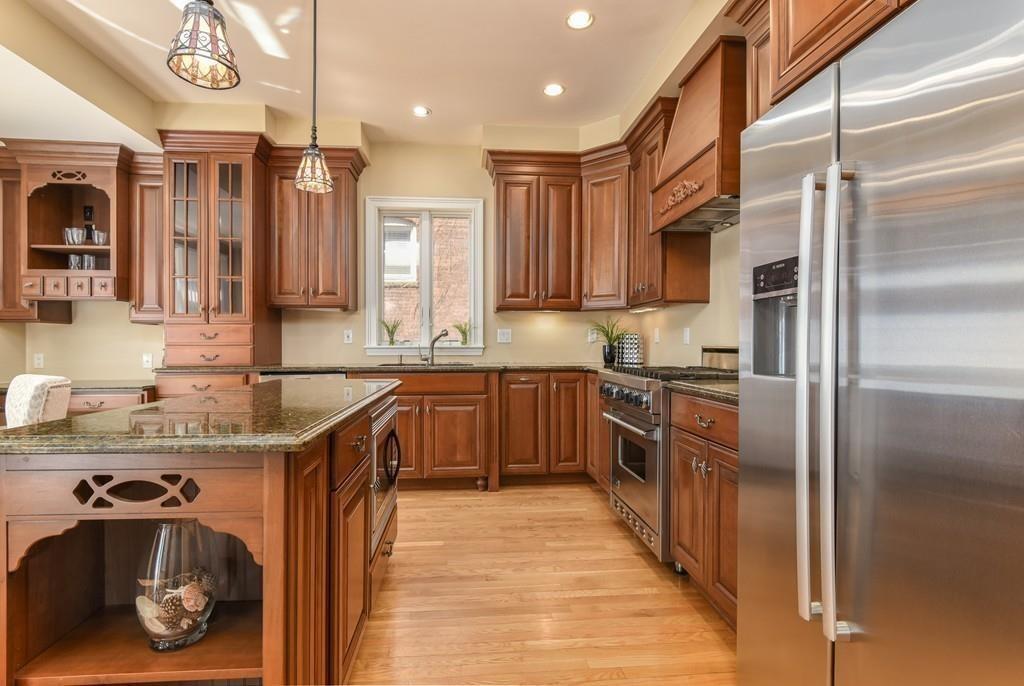 41 University Road Brookline, MA 02445 - Photo 12 of 37 a kitchen with stainless steel appliances granite countertop a sink a stove and a refrigerator
