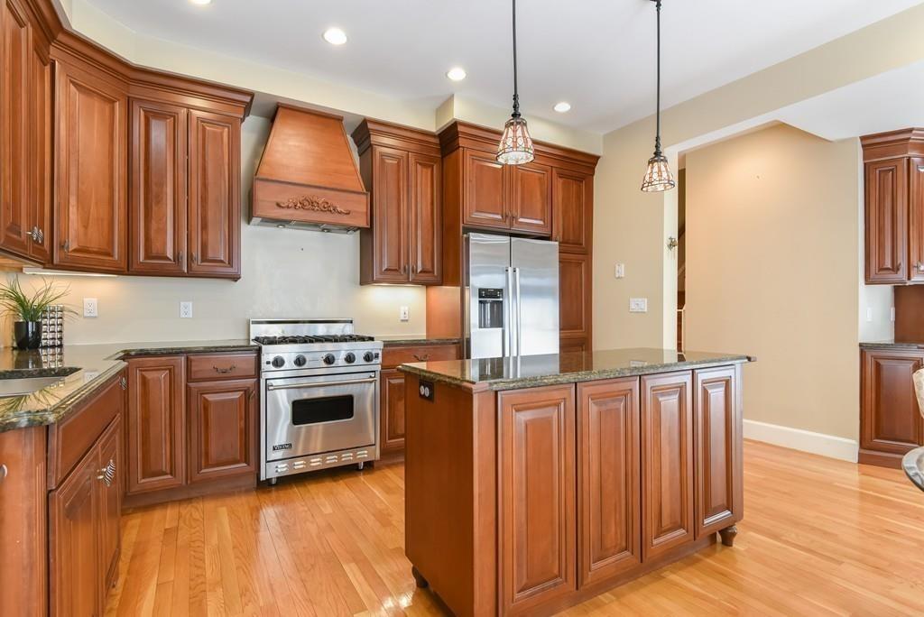 41 University Road Brookline, MA 02445 - Photo 13 of 37 a kitchen with stainless steel appliances granite countertop a refrigerator a sink and a stove