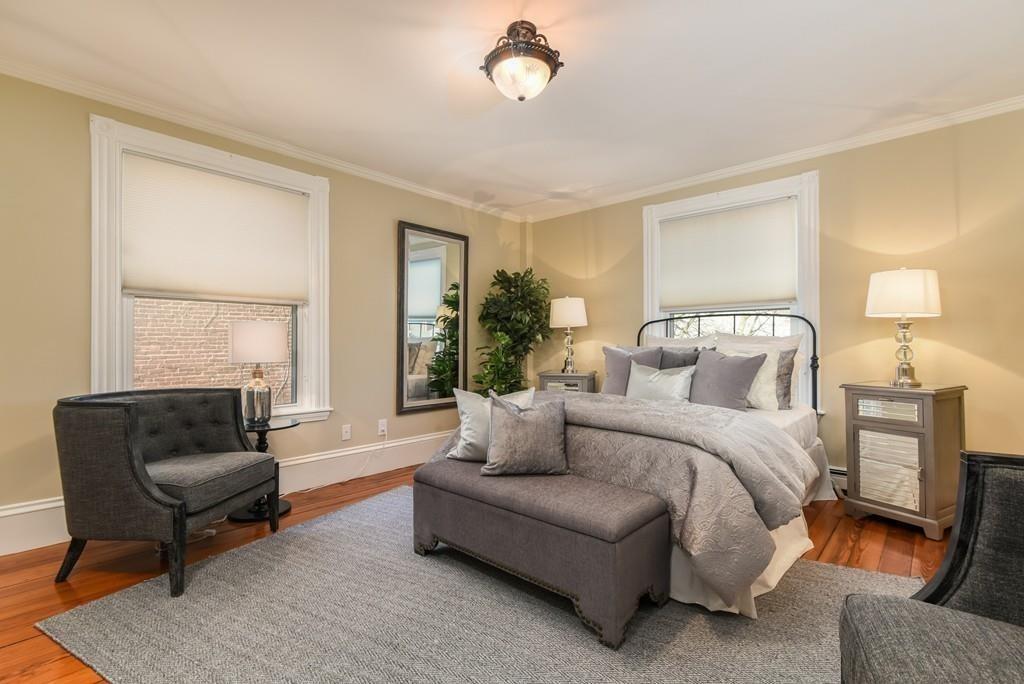 41 University Road Brookline, MA 02445 - Photo 18 of 37 a spacious bedroom with a bed a couch and a window