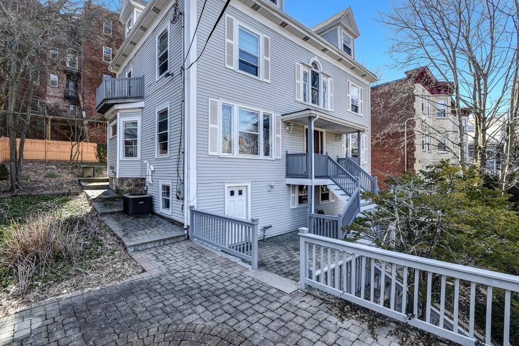 41 University Road Brookline, MA 02445 - Photo 2 of 37 a view of a brick house with many windows next to a yard