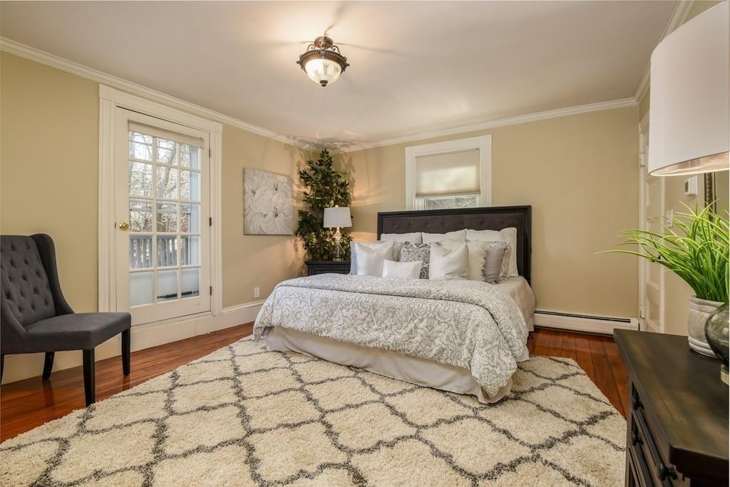 41 University Road Brookline, MA 02445 - Photo 23 of 37 a spacious bedroom with a bed and a chair