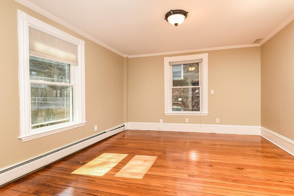 41 University Road Brookline, MA 02445 - Photo 25 of 37 a view of an empty room with wooden floor and a window