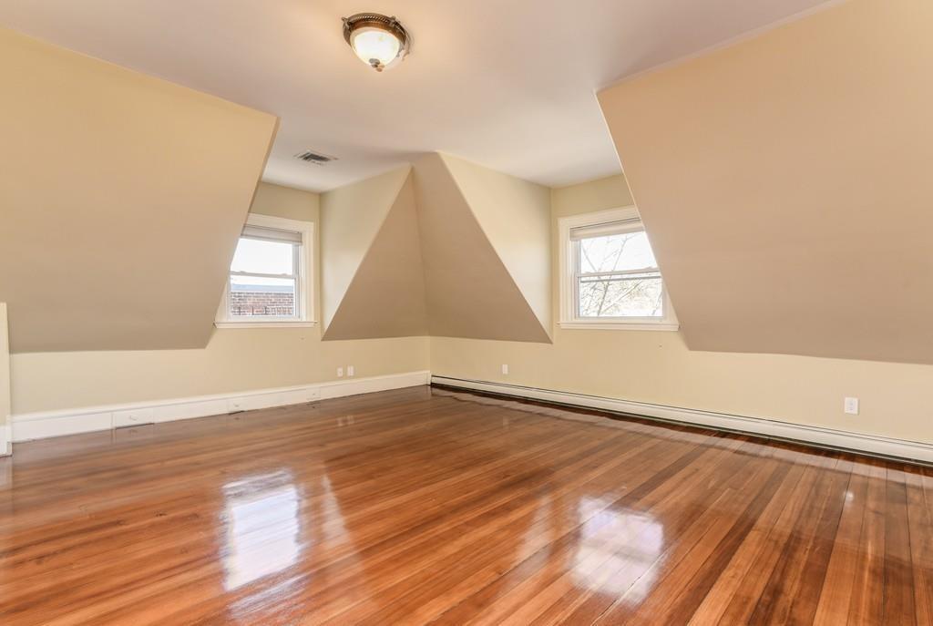 41 University Road Brookline, MA 02445 - Photo 26 of 37 an empty room with wooden floor and windows