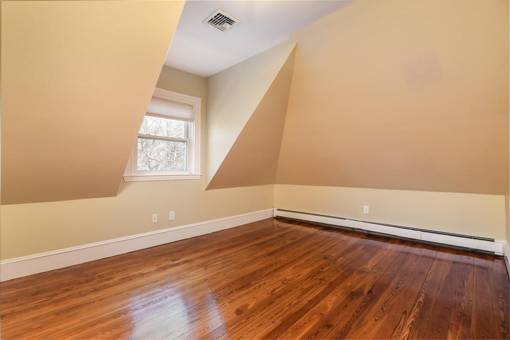 41 University Road Brookline, MA 02445 - Photo 27 of 37 an empty room with wooden floor and windows