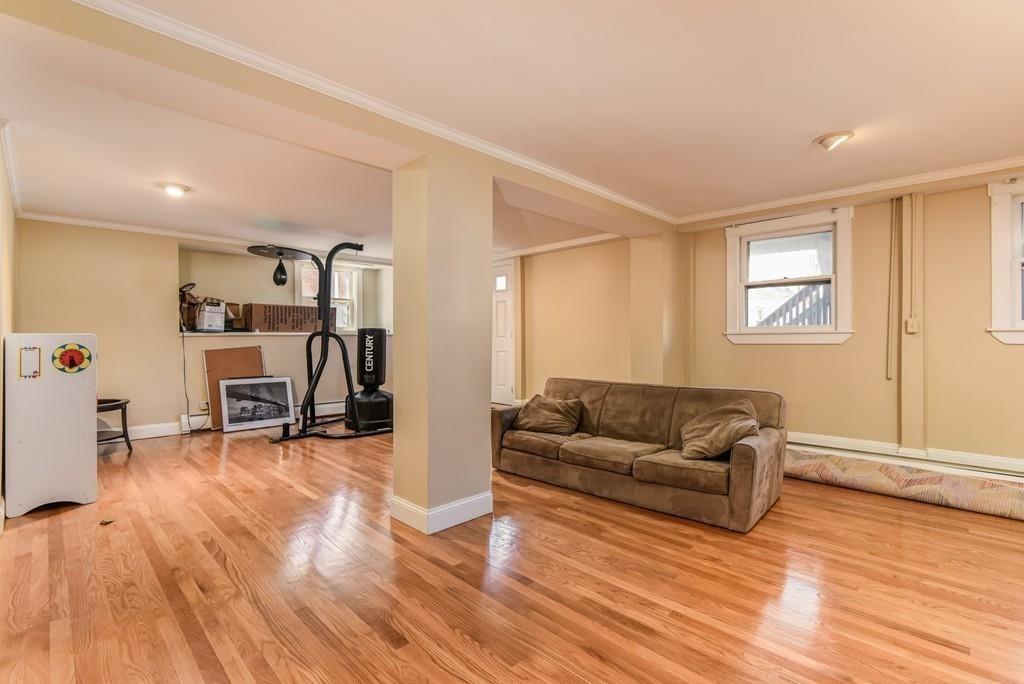 41 University Road Brookline, MA 02445 - Photo 28 of 37 a living room with furniture and a wooden floor
