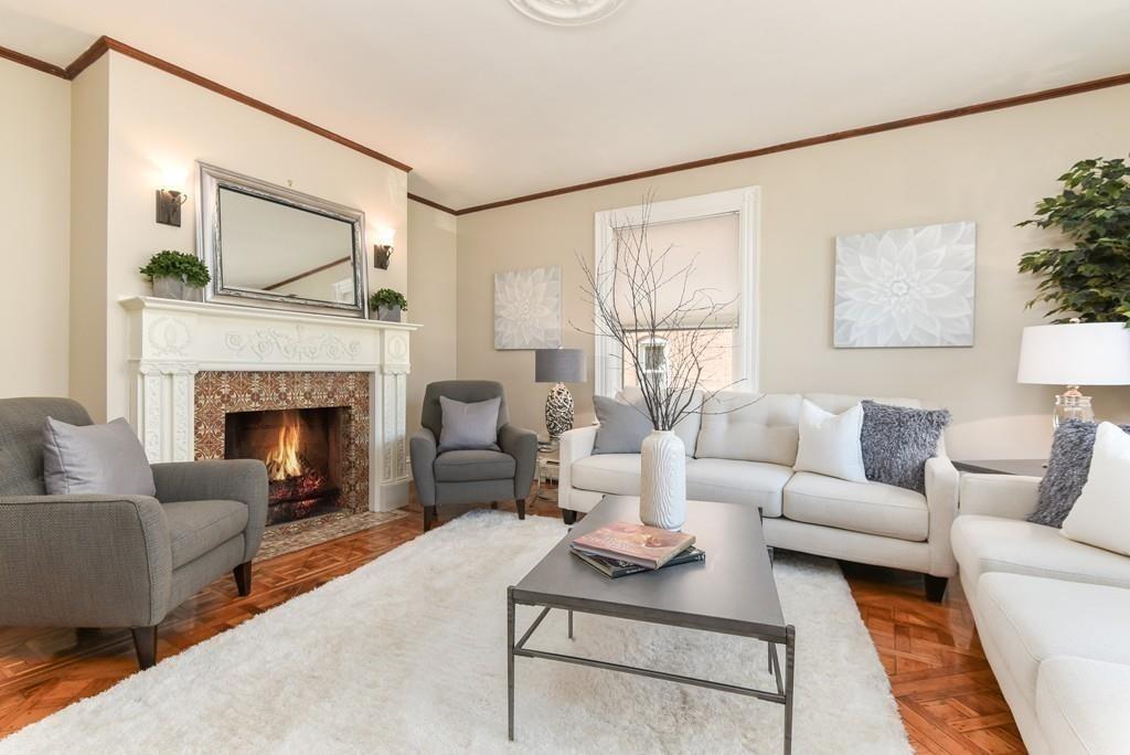 41 University Road Brookline, MA 02445 - Photo 3 of 37 a living room with furniture a fireplace and a large mirror next to a window