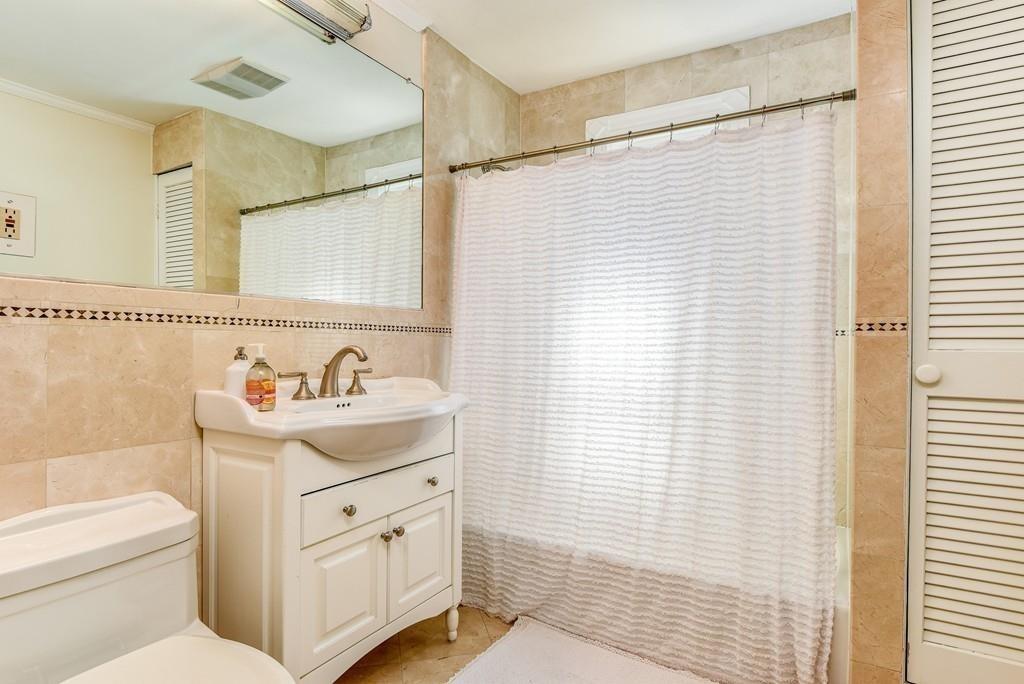 41 University Road Brookline, MA 02445 - Photo 31 of 37 a bathroom with a sink a toilet and a shower
