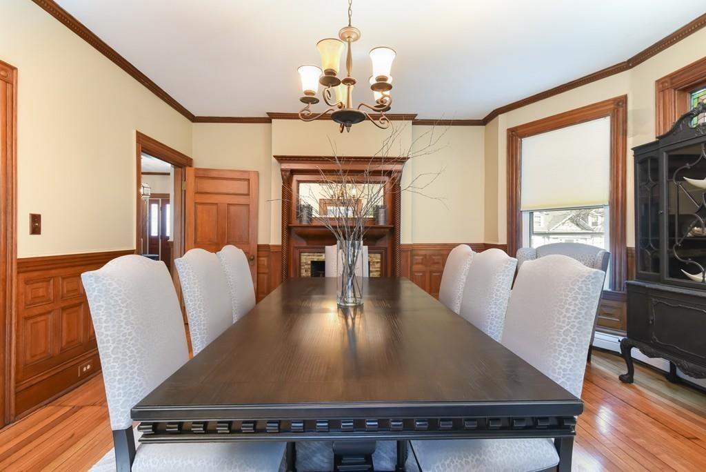 41 University Road Brookline, MA 02445 - Photo 9 of 37 a view of a dining room with furniture a chandelier and wooden floor