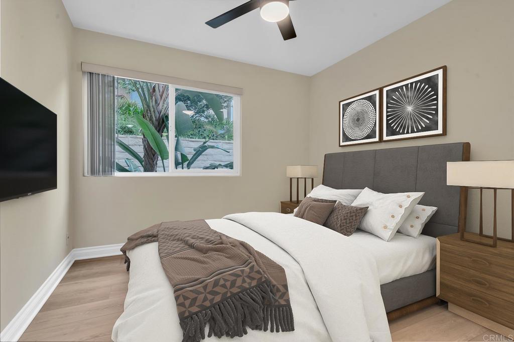 8636 Via Mallorca, Unit A La Jolla, CA 92037 - Photo 8 of 21 a bedroom with a bed and a flat screen tv
