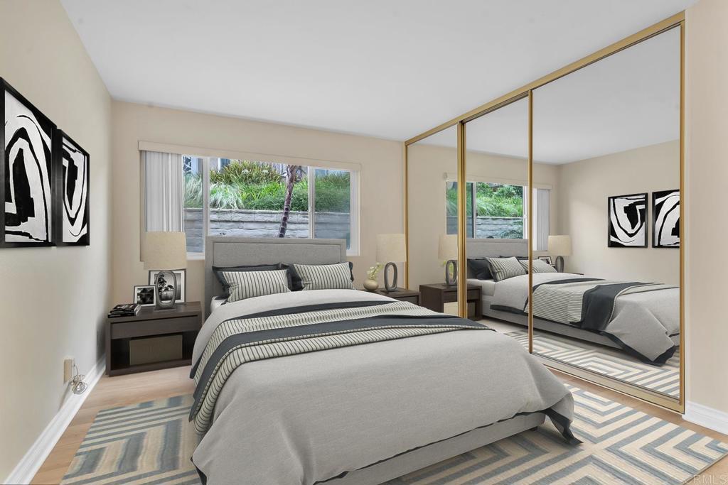 8636 Via Mallorca, Unit A La Jolla, CA 92037 - Photo 10 of 21 a bedroom with a bed couch and a large window