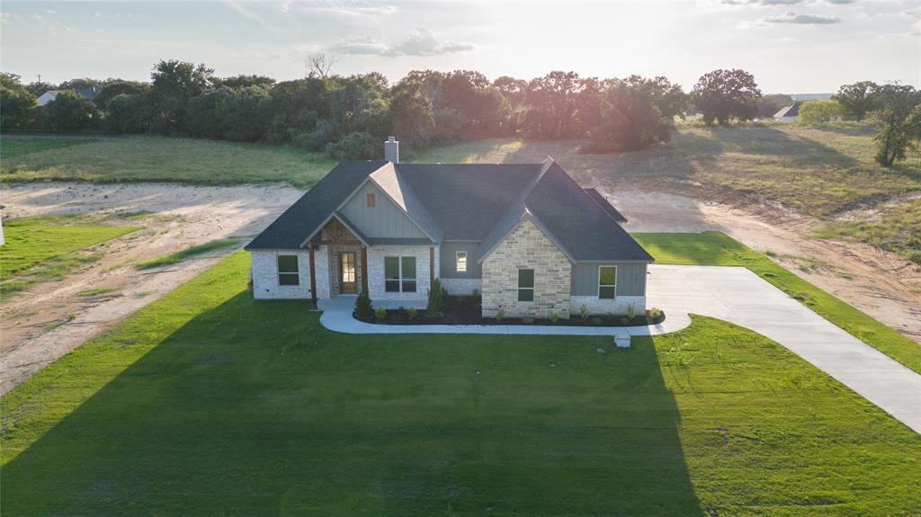 141 Prairie Winds Drive Poolville, TX 76487 - Photo 5 of 15 a aerial view of residential houses with outdoor space and trees