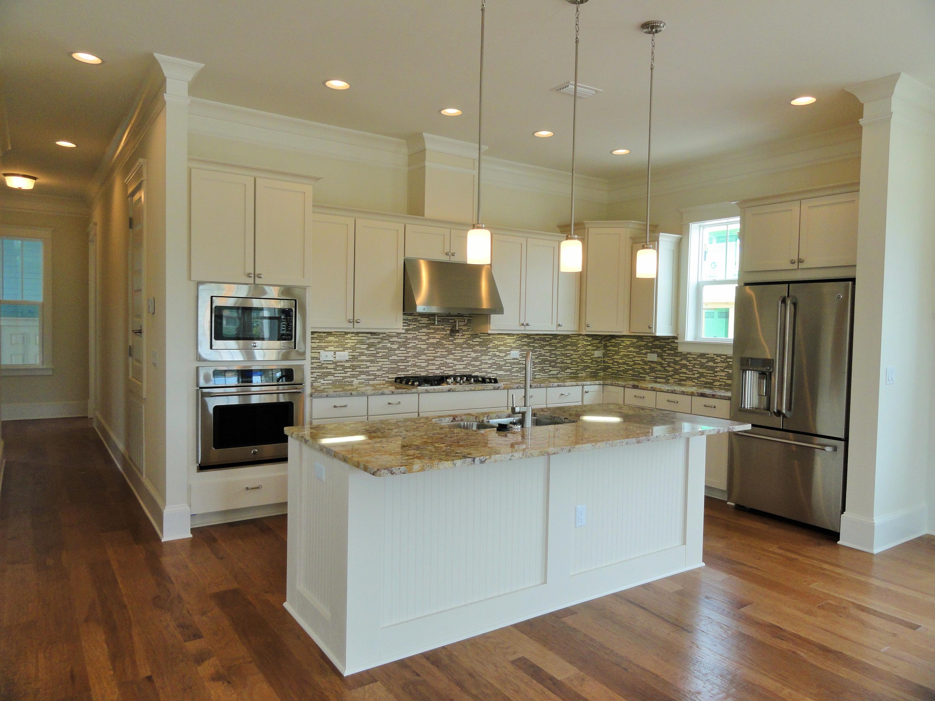 89 Clipper Street Inlet Beach, FL 32461 - Photo 11 of 50 a large kitchen with kitchen island a stove a sink a refrigerator and a wooden floor