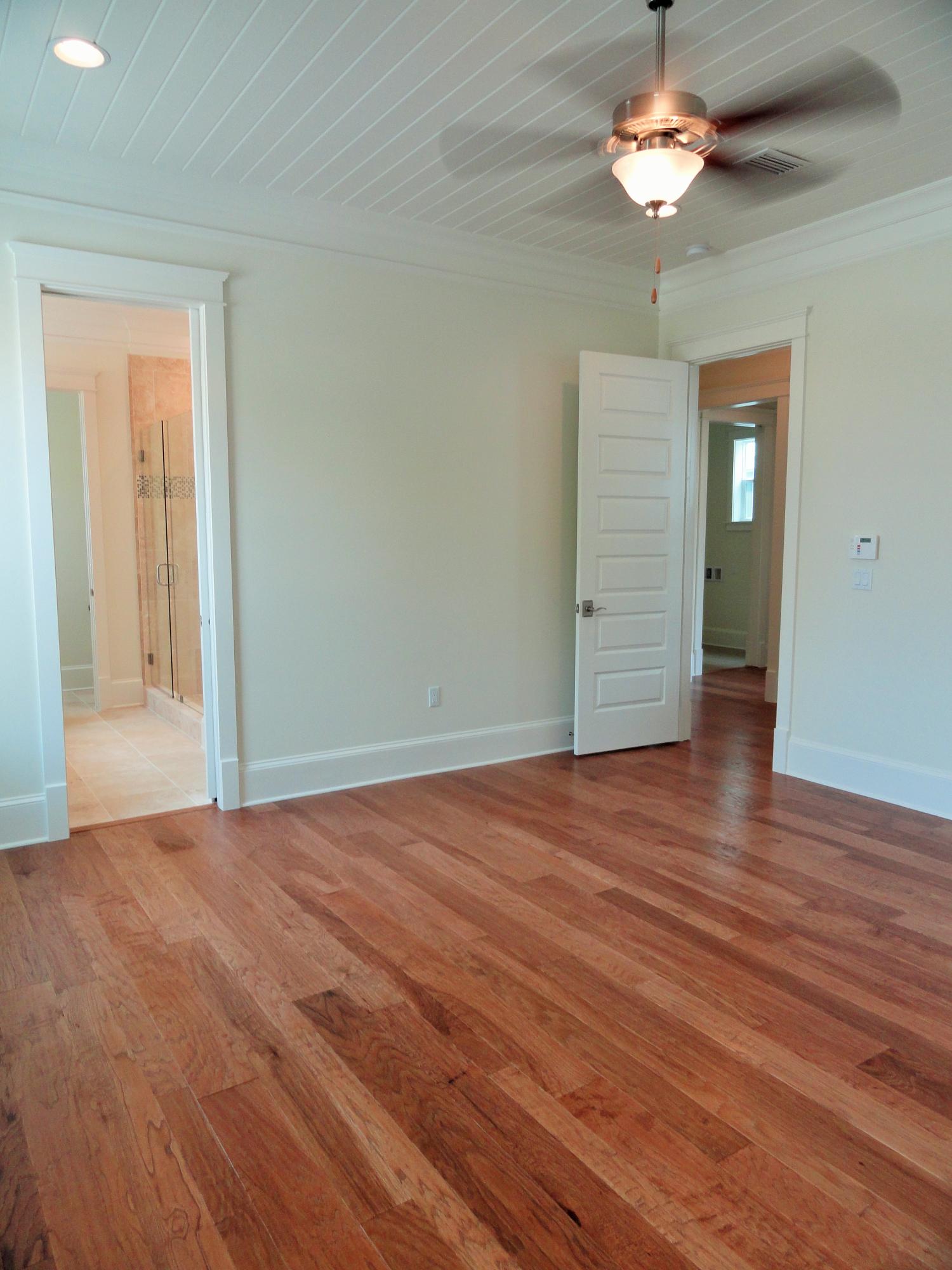 89 Clipper Street Inlet Beach, FL 32461 - Photo 21 of 50 an empty room with wooden floor chandelier fan and windows