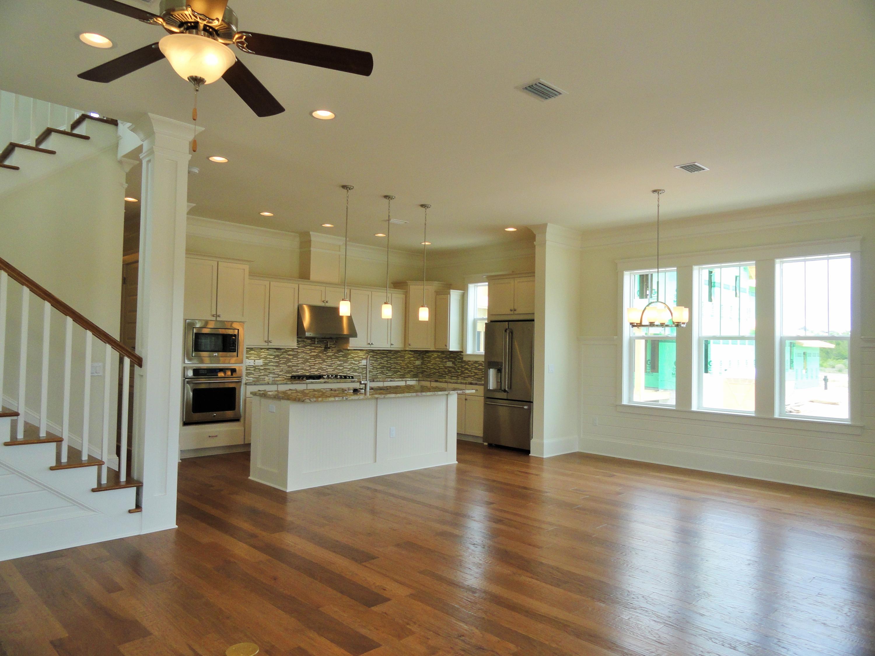 89 Clipper Street Inlet Beach, FL 32461 - Photo 9 of 50 a open kitchen with stainless steel appliances granite countertop a refrigerator a sink dishwasher a stove and white countertops with wooden floor