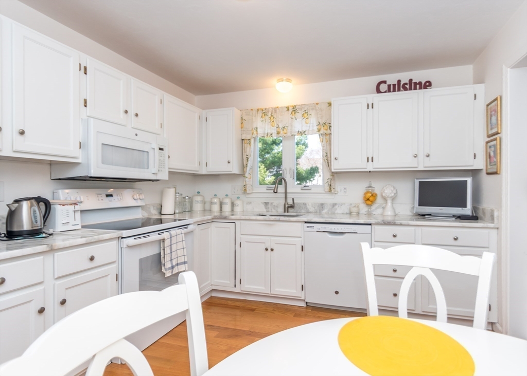 46 Timberline Road Millis, MA 02054 - Photo 12 of 38 a kitchen with cabinets stainless steel appliances a sink and a stove