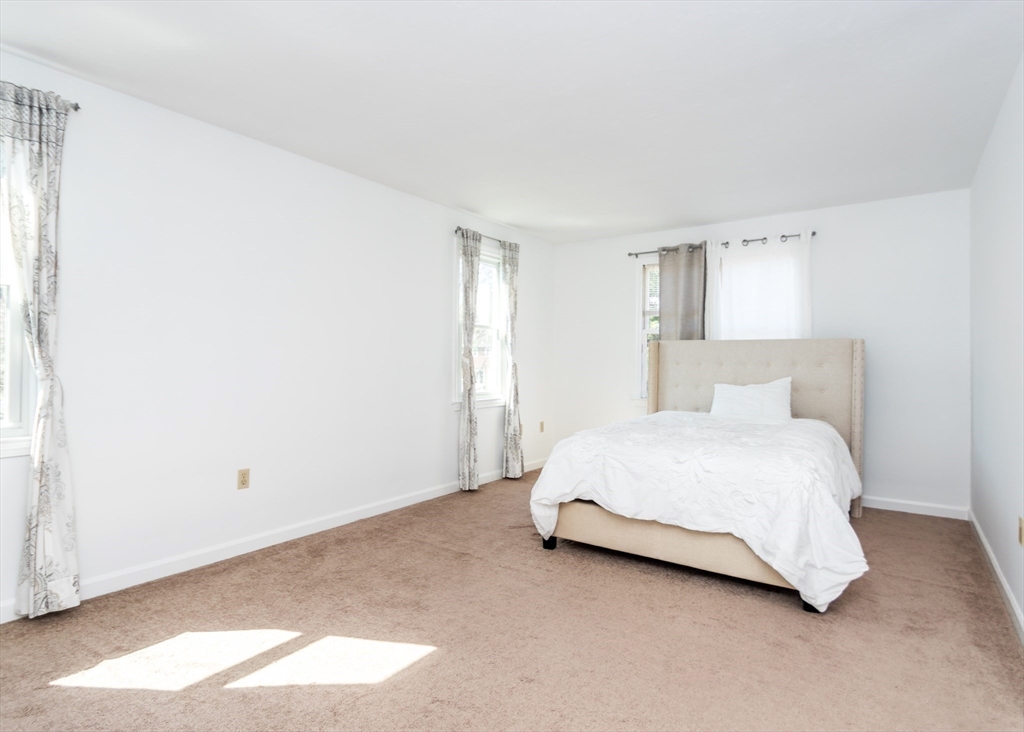 46 Timberline Road Millis, MA 02054 - Photo 17 of 38 a spacious bedroom with a bed and a window