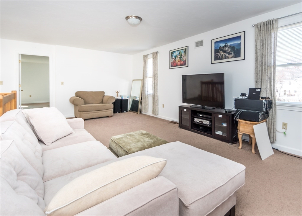 46 Timberline Road Millis, MA 02054 - Photo 20 of 38 a living room with furniture and a flat screen tv