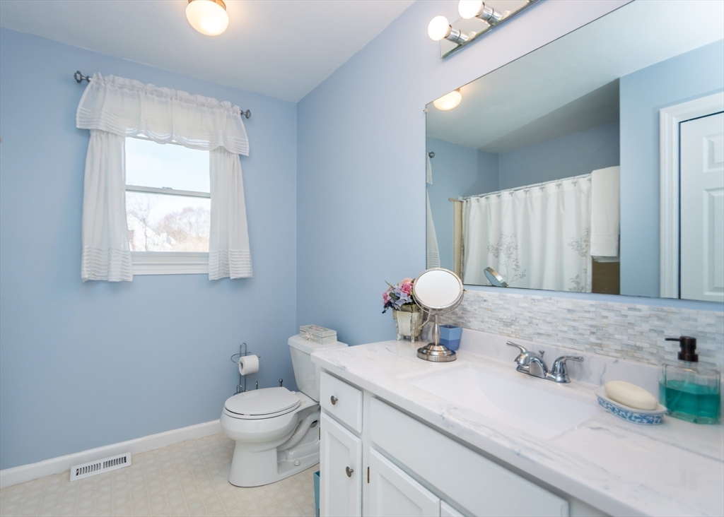 46 Timberline Road Millis, MA 02054 - Photo 23 of 38 a bathroom with a granite countertop sink mirror vanity and toilet
