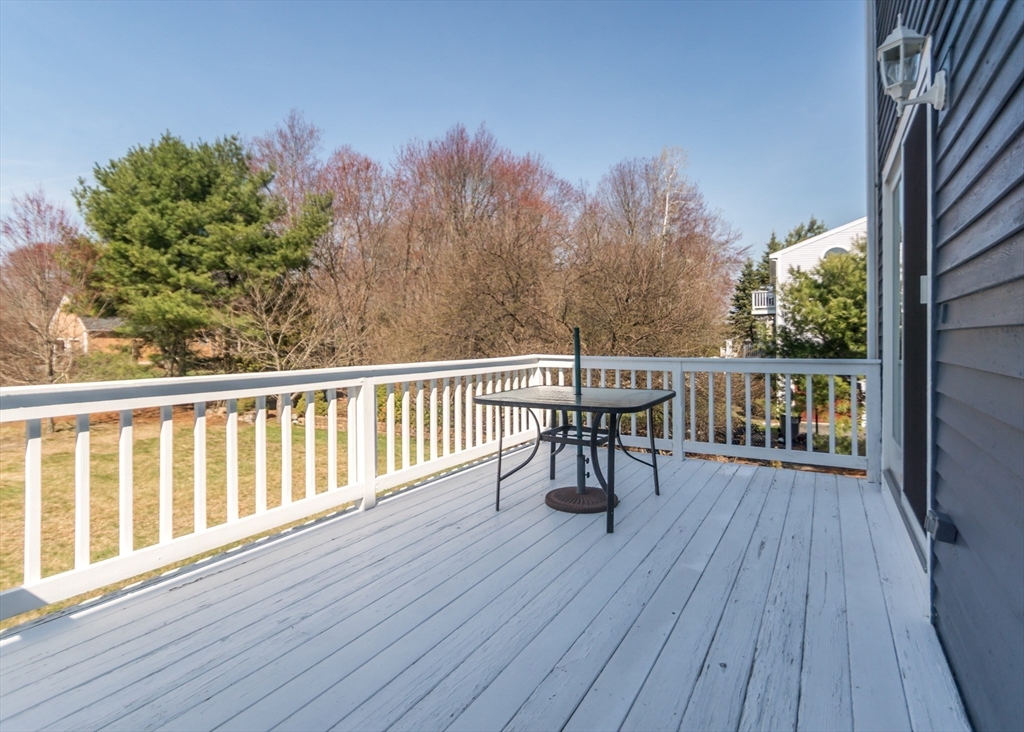 46 Timberline Road Millis, MA 02054 - Photo 35 of 38 a view of a deck with wooden floor and fence with a bench