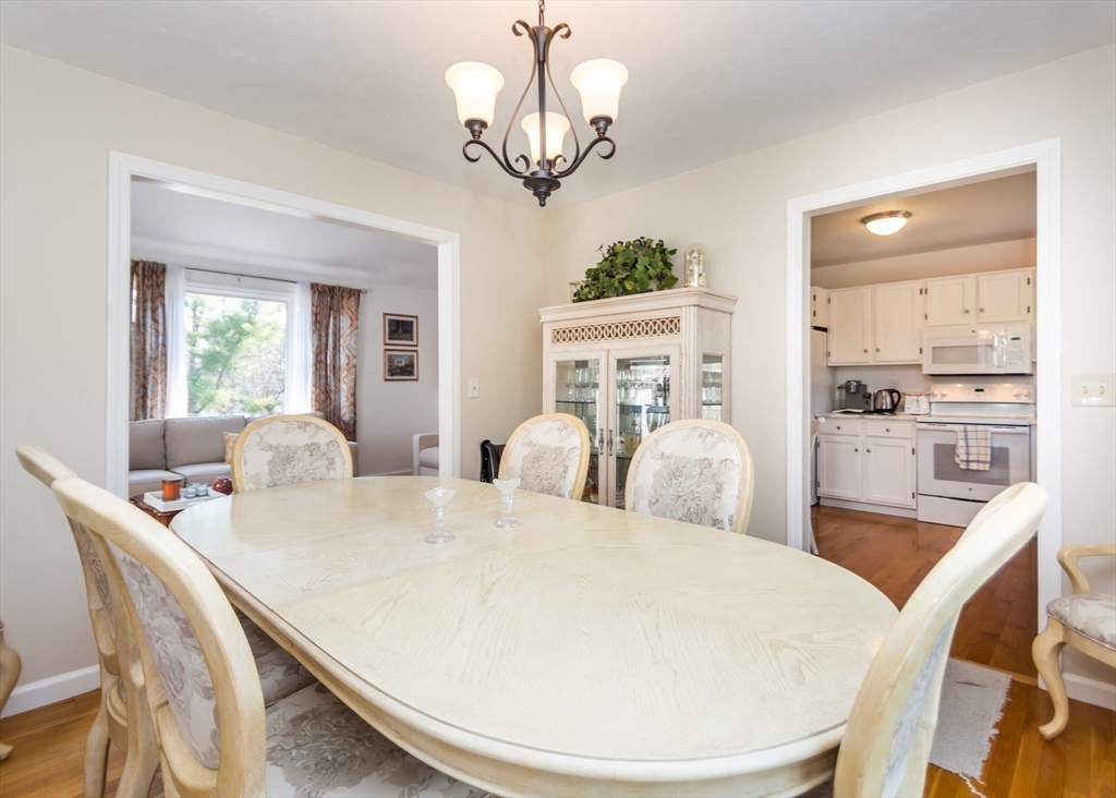 46 Timberline Road Millis, MA 02054 - Photo 7 of 38 a view of a dining room with furniture a chandelier and wooden floor