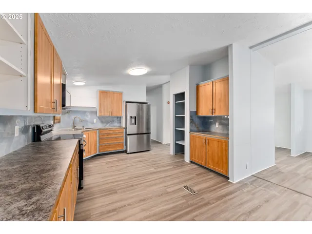 a bathroom with a sink a mirror and a shower