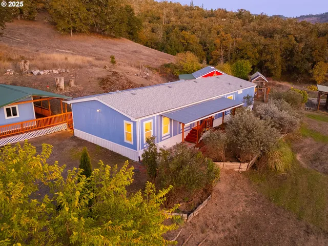 an aerial view of a house with a yard