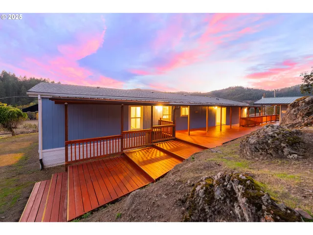 a view of swimming pool with a table and chairs under an umbrella