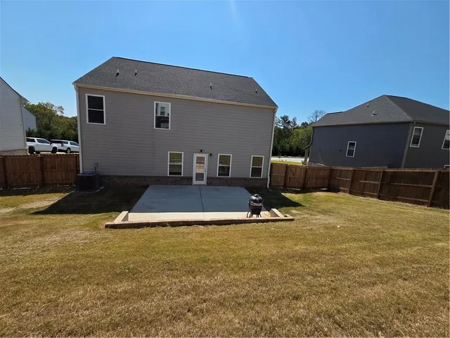 a backyard of a house with table and chairs