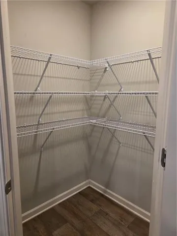 a view of a room with wooden floor