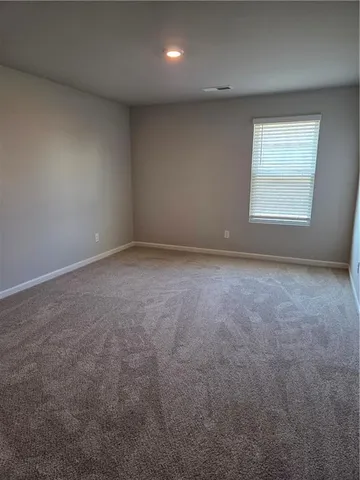 an empty room with a empty space and windows