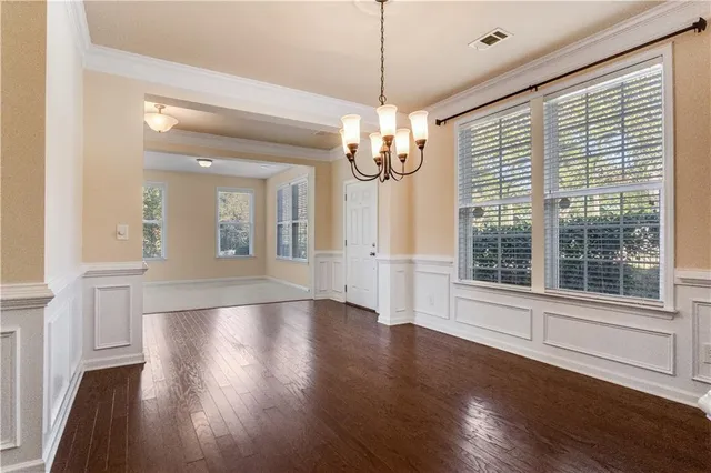 a view of a room with wooden floor and cabinet