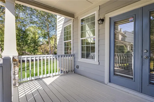 an empty room with a ceiling fan and window