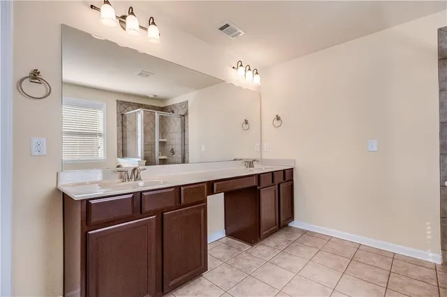 a bathroom with a granite countertop sink a toilet and a mirror