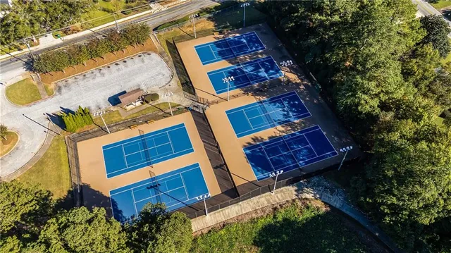 a sign that is sitting in front of a brick house