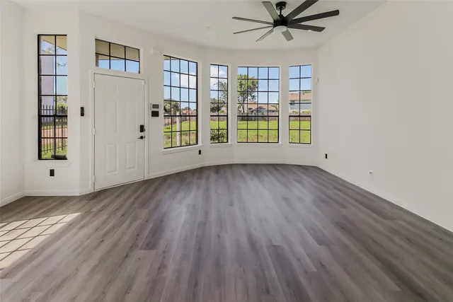 wooden floor in an empty room with a window