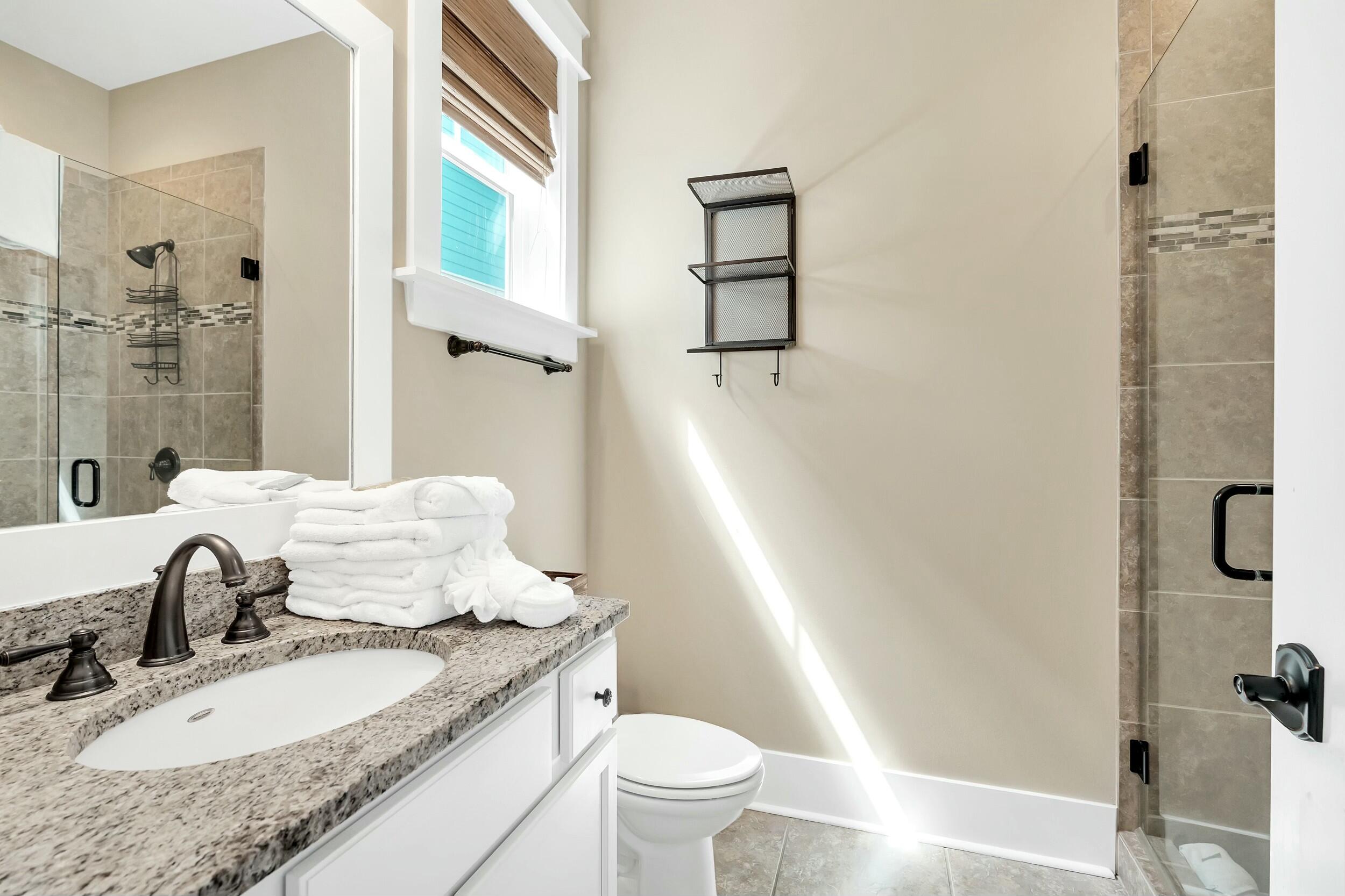 673 Flatwoods Forest Loop Santa Rosa Beach, FL 32459 - Photo 12 of 41 a bathroom with a granite countertop sink toilet and shower