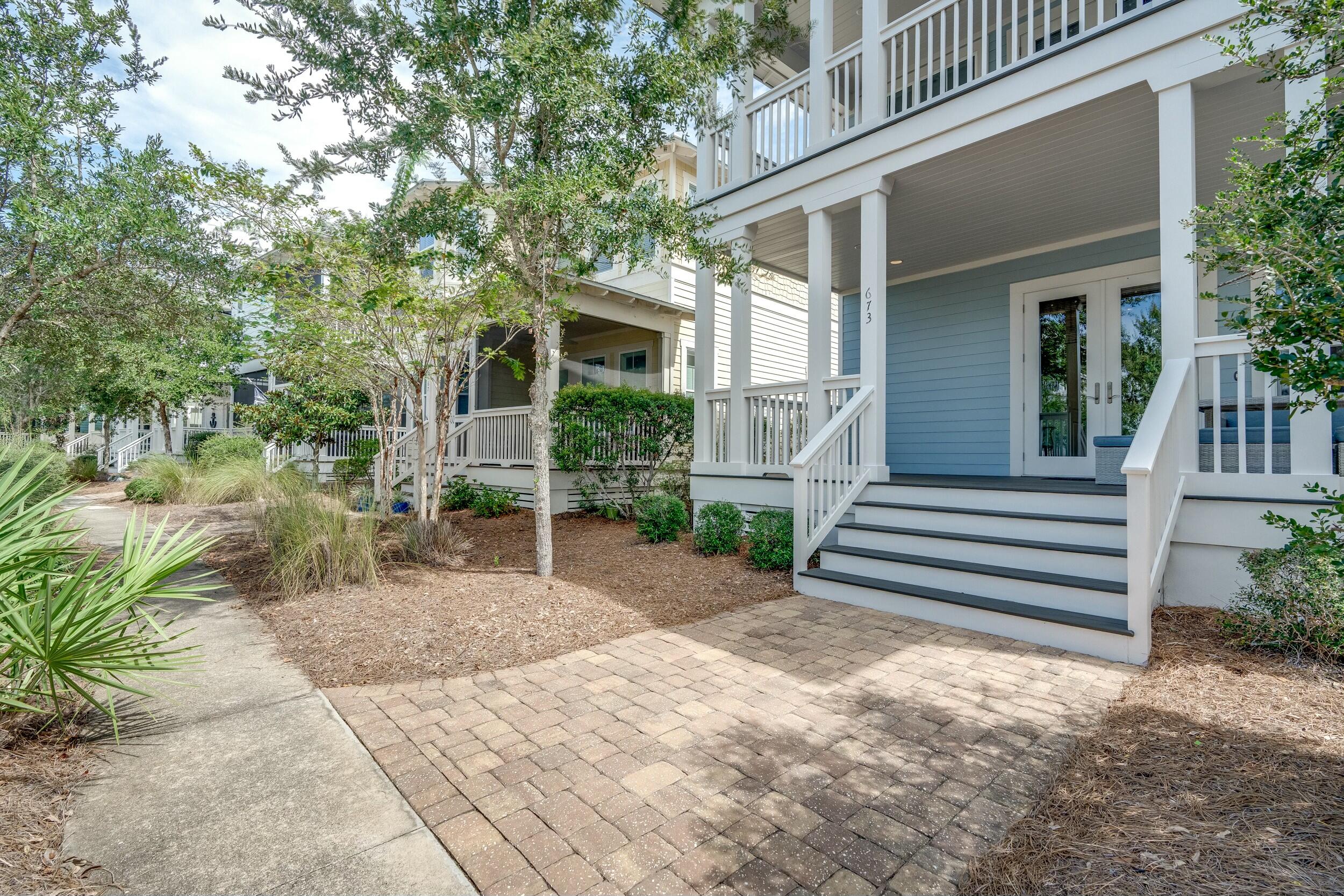 673 Flatwoods Forest Loop Santa Rosa Beach, FL 32459 - Photo 2 of 41 a front view of a house with a garden