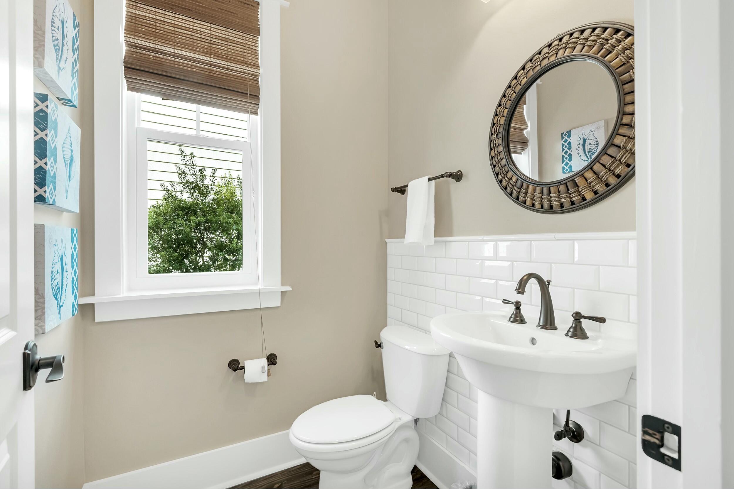 673 Flatwoods Forest Loop Santa Rosa Beach, FL 32459 - Photo 25 of 41 a bathroom with a toilet a sink a mirror and a window