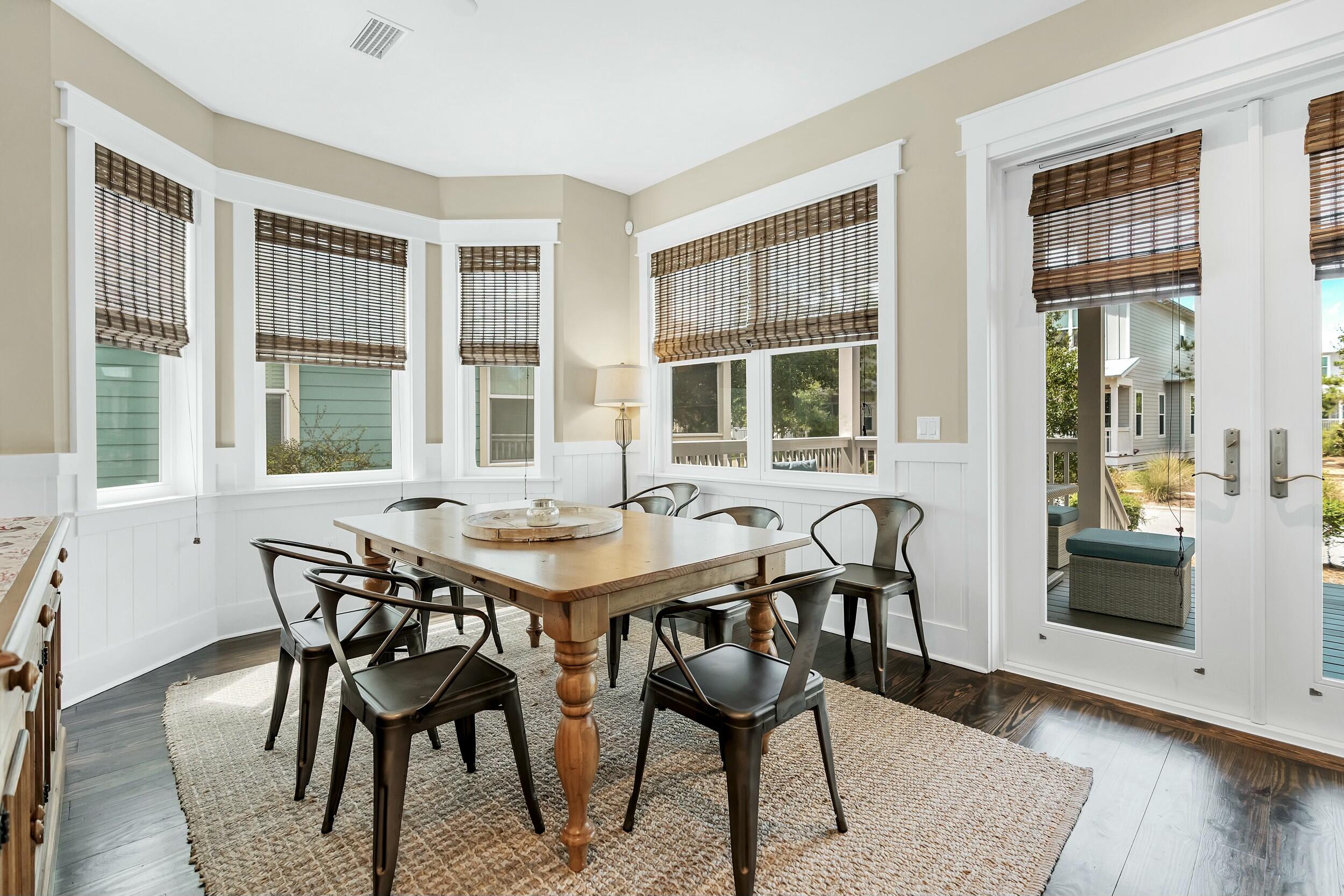 673 Flatwoods Forest Loop Santa Rosa Beach, FL 32459 - Photo 6 of 41 a view of a dining room with furniture and wooden floor