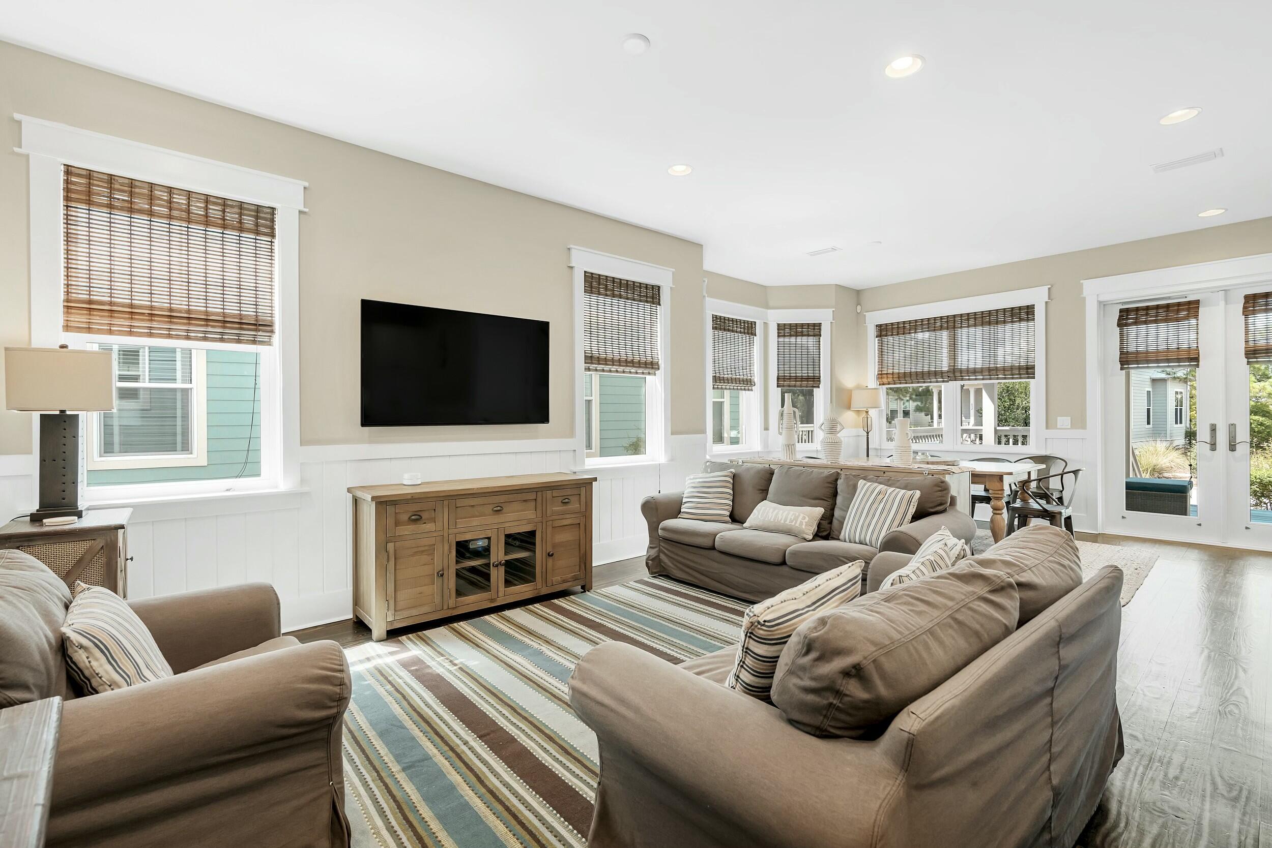 673 Flatwoods Forest Loop Santa Rosa Beach, FL 32459 - Photo 7 of 41 a living room with furniture a flat screen tv and a fireplace