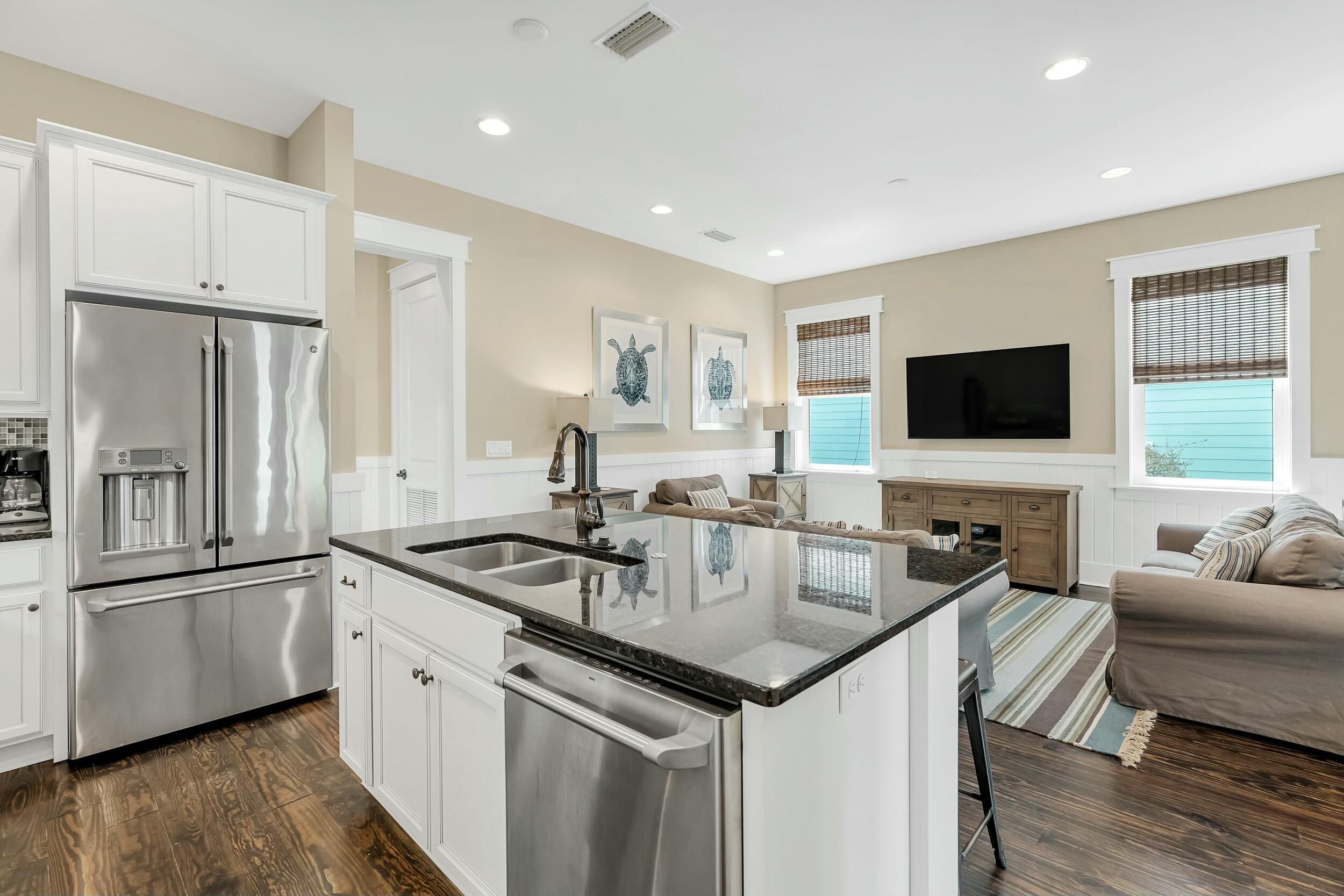 673 Flatwoods Forest Loop Santa Rosa Beach, FL 32459 - Photo 10 of 41 a kitchen with stainless steel appliances granite countertop a sink and a refrigerator