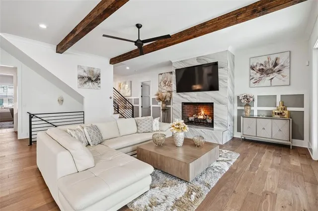 a large kitchen with cabinets wooden floor stainless steel appliances and dining table