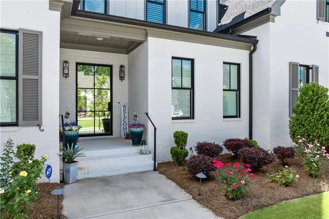 a kitchen with stainless steel appliances a sink a stove and a wooden floors