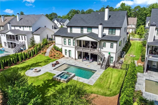 an aerial view of a house with swimming pool lawn chairs and a yard