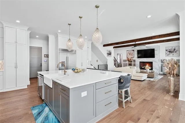 a view of a walk in closet with clothes and shoes