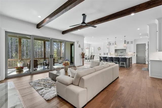 a living room with furniture and kitchen view