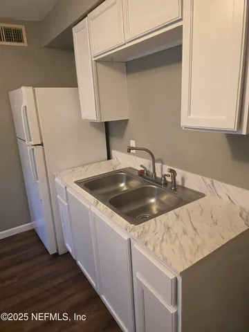 a kitchen with a sink and a refrigerator