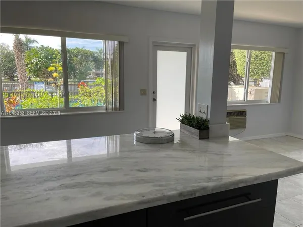 a view of kitchen with granite countertop window