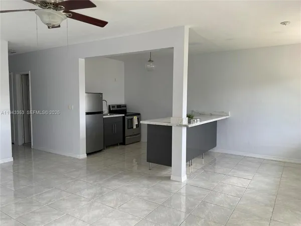 a kitchen with cabinets and stainless steel appliances