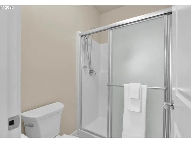 a bathroom with a shower and a toilet